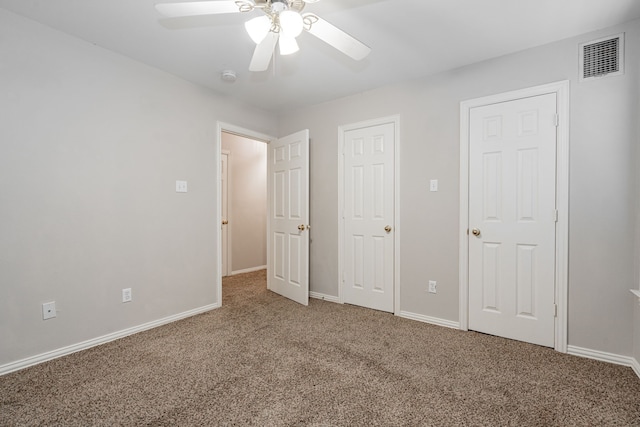 unfurnished bedroom with ceiling fan and carpet floors