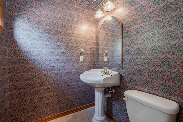 bathroom with toilet and tile patterned floors