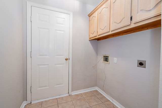 clothes washing area featuring hookup for a washing machine, electric dryer hookup, light tile patterned floors, and cabinets