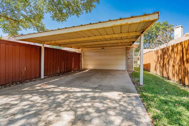 garage featuring a yard and a carport