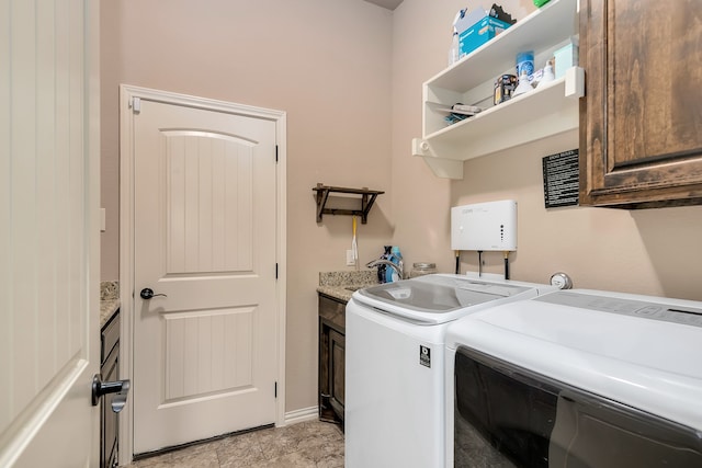 laundry room featuring cabinets and washer and clothes dryer