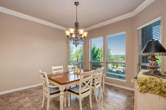 dining room with ornamental molding and a notable chandelier