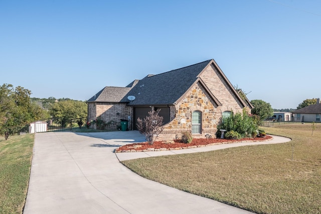 view of front of property with a garage and a front lawn