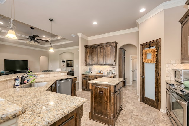 kitchen with crown molding, sink, stainless steel appliances, hanging light fixtures, and a center island