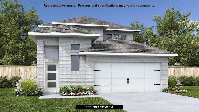 view of front of home with a front yard and a garage