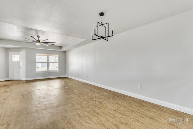 unfurnished living room with a textured ceiling, wood-type flooring, and ceiling fan with notable chandelier