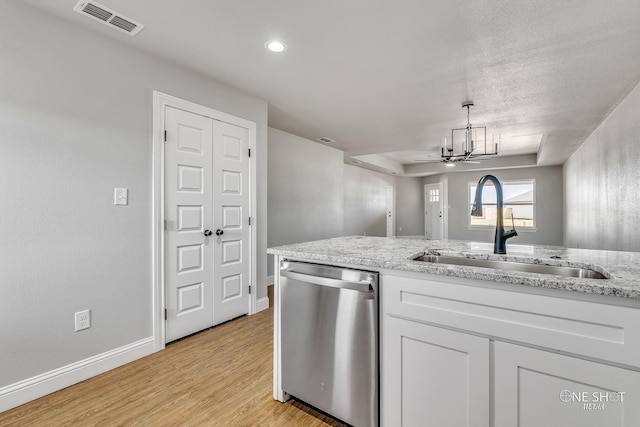 kitchen with dishwasher, white cabinets, sink, and light wood-type flooring