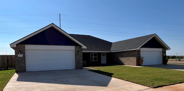 view of front of house featuring a front yard and a garage