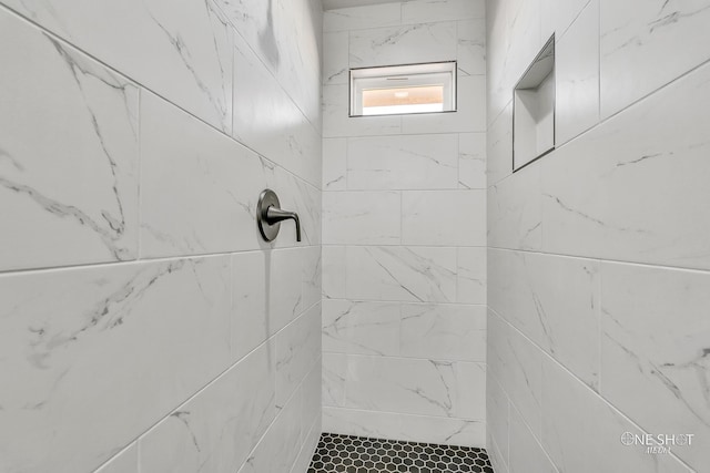 bathroom with a tile shower