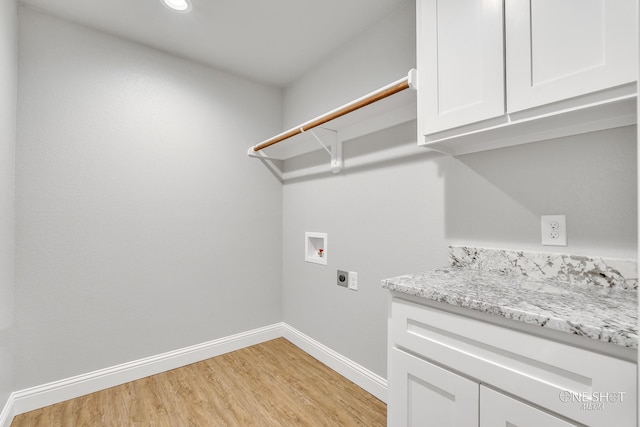 clothes washing area featuring hookup for an electric dryer, light hardwood / wood-style flooring, washer hookup, and cabinets