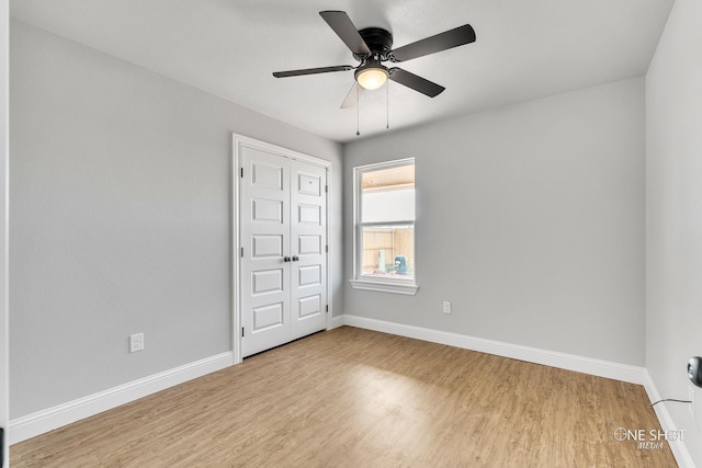 unfurnished bedroom with light hardwood / wood-style floors, a closet, and ceiling fan