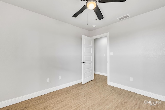 empty room featuring ceiling fan and light hardwood / wood-style flooring