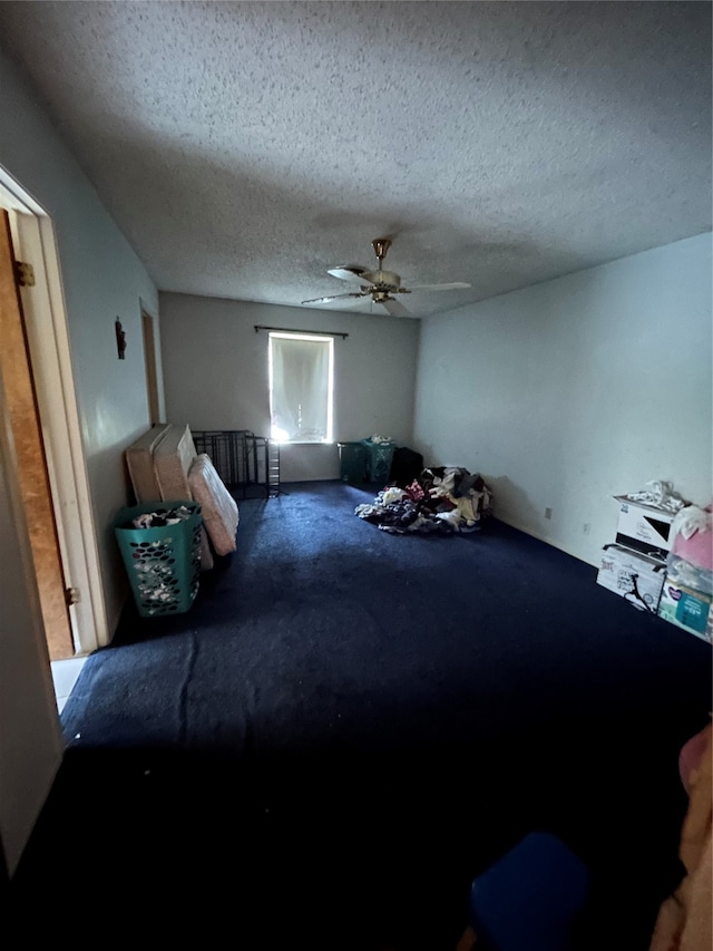 unfurnished bedroom featuring carpet flooring, ceiling fan, and a textured ceiling