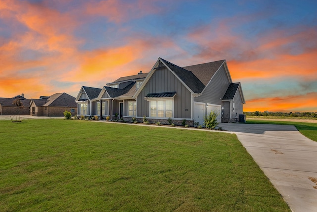 view of front of property featuring a garage and a yard