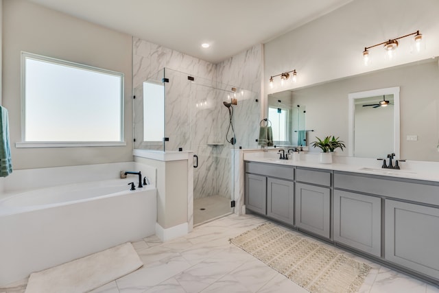 bathroom featuring ceiling fan, vanity, and separate shower and tub