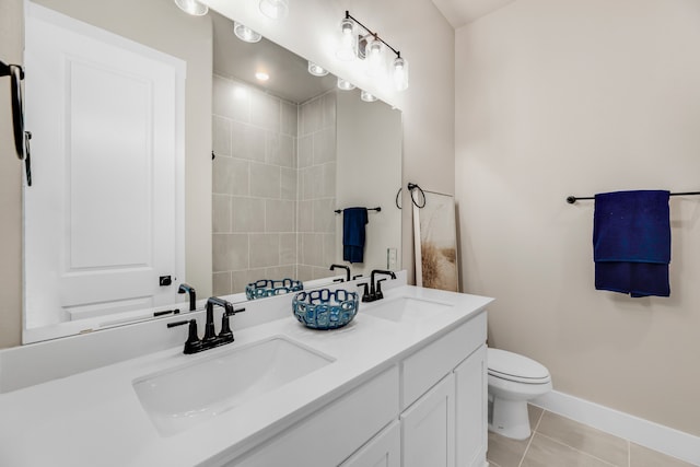 bathroom with vanity, toilet, and tile patterned floors