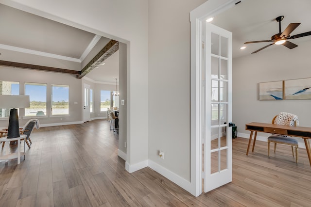 corridor with french doors, ornamental molding, and light hardwood / wood-style floors