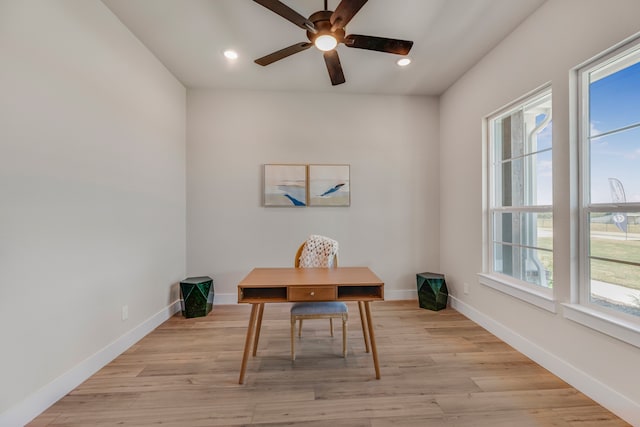 office area featuring light wood-type flooring, a healthy amount of sunlight, and ceiling fan