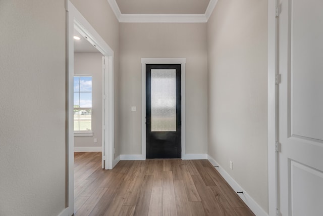 foyer with crown molding and light hardwood / wood-style floors