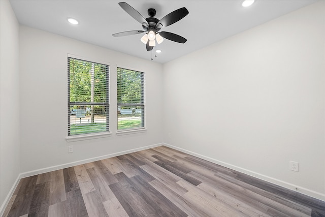 empty room featuring ceiling fan and light hardwood / wood-style flooring