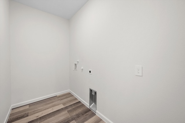 washroom with wood-type flooring, electric dryer hookup, hookup for a washing machine, and gas dryer hookup