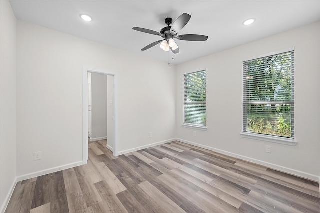 interior space with ceiling fan, a walk in closet, and light hardwood / wood-style flooring