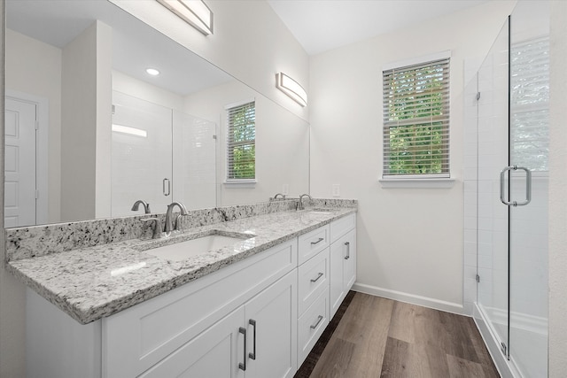 bathroom featuring walk in shower, vanity, and hardwood / wood-style floors