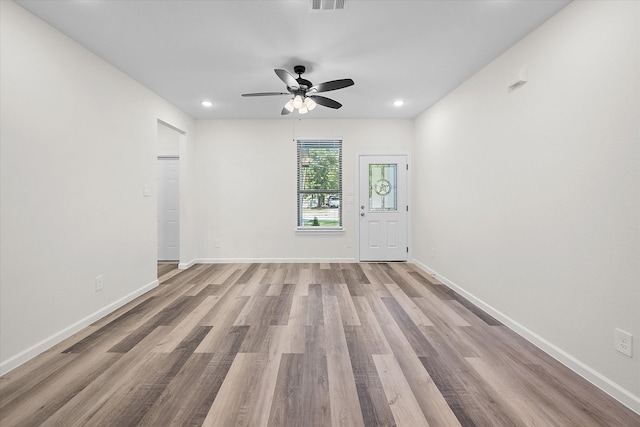 spare room featuring light hardwood / wood-style floors and ceiling fan