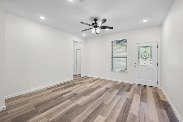 empty room featuring light hardwood / wood-style flooring and ceiling fan