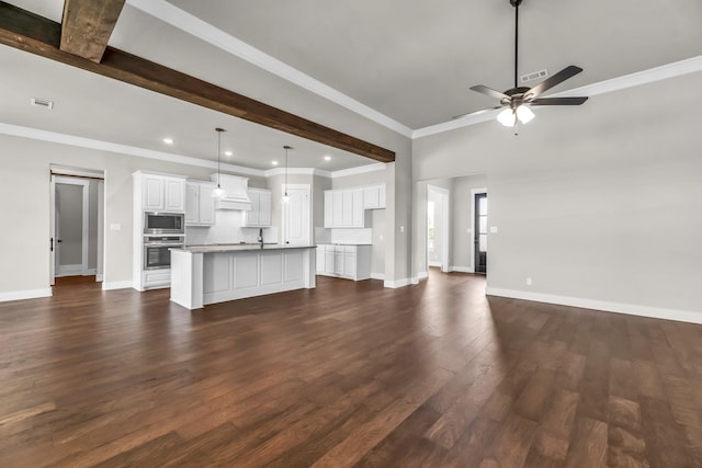 unfurnished living room featuring ornamental molding, ceiling fan, dark wood-type flooring, sink, and beamed ceiling