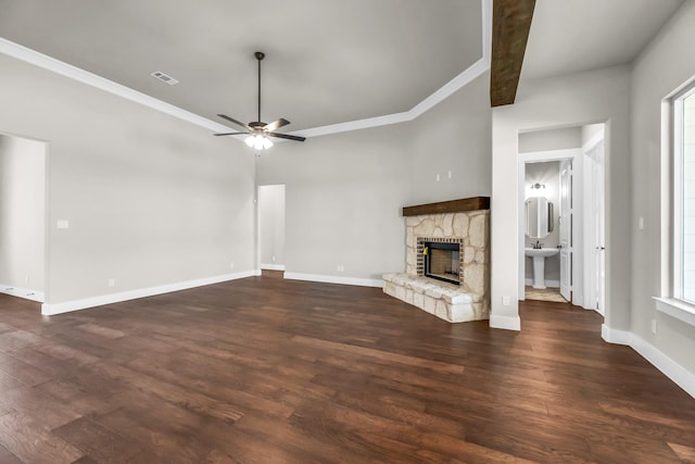 unfurnished living room with dark hardwood / wood-style flooring, plenty of natural light, a fireplace, and ornamental molding