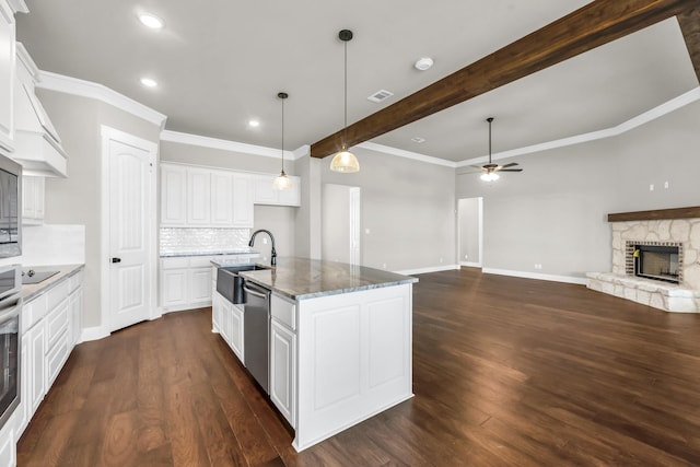 kitchen featuring white cabinets, dark hardwood / wood-style flooring, sink, and a kitchen island with sink