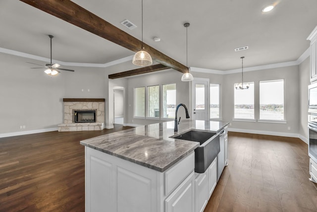 kitchen with white cabinetry, sink, and a wealth of natural light