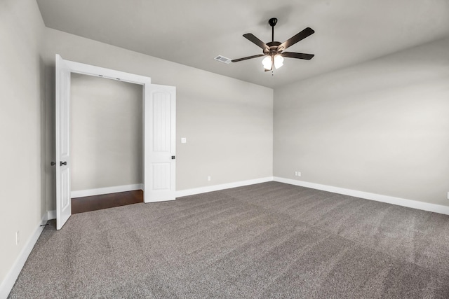 unfurnished bedroom featuring ceiling fan and dark colored carpet