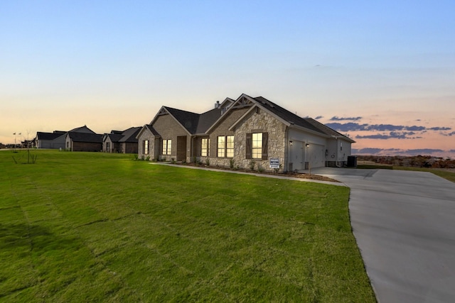 view of front facade featuring a lawn and a garage