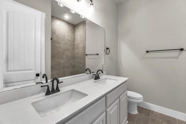 bathroom with tile patterned floors, vanity, and toilet