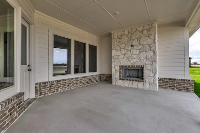 view of patio / terrace featuring an outdoor stone fireplace