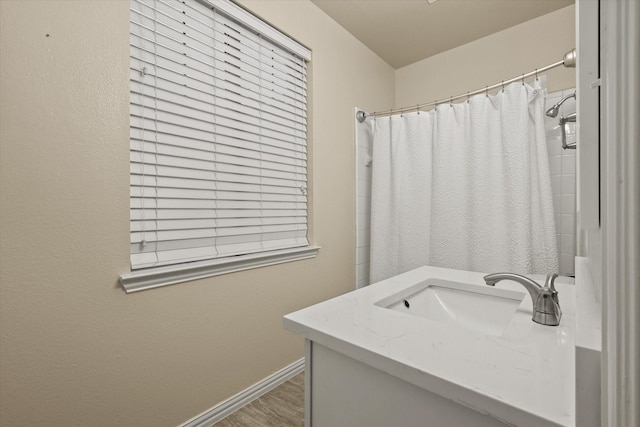 bathroom featuring hardwood / wood-style floors, vanity, and curtained shower