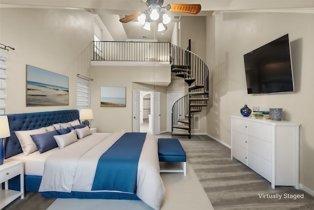 bedroom featuring carpet flooring, a towering ceiling, and ceiling fan