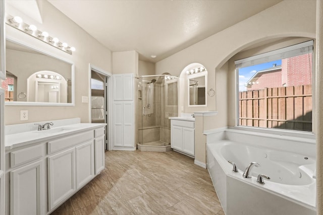 bathroom featuring plus walk in shower and vanity