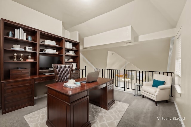 carpeted home office with lofted ceiling