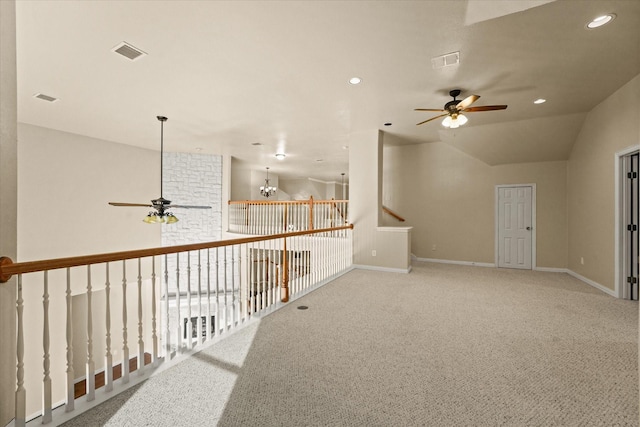 corridor with carpet flooring, an inviting chandelier, and lofted ceiling