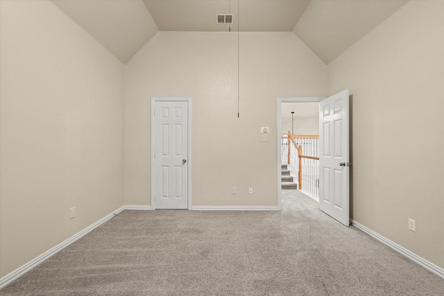 empty room with carpet and vaulted ceiling