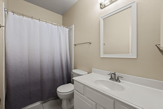 bathroom featuring tile patterned floors, vanity, curtained shower, and toilet