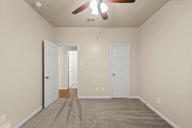 unfurnished bedroom featuring light carpet and ceiling fan