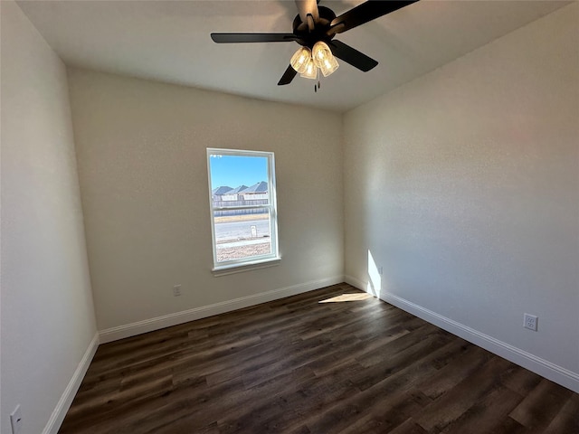 unfurnished room with ceiling fan and dark hardwood / wood-style floors