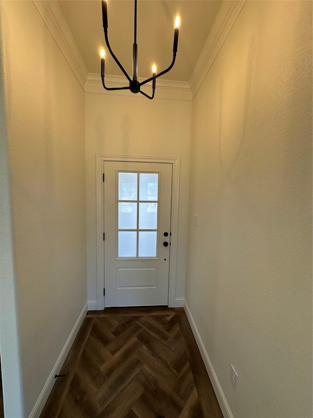 doorway featuring a notable chandelier, dark parquet flooring, and ornamental molding