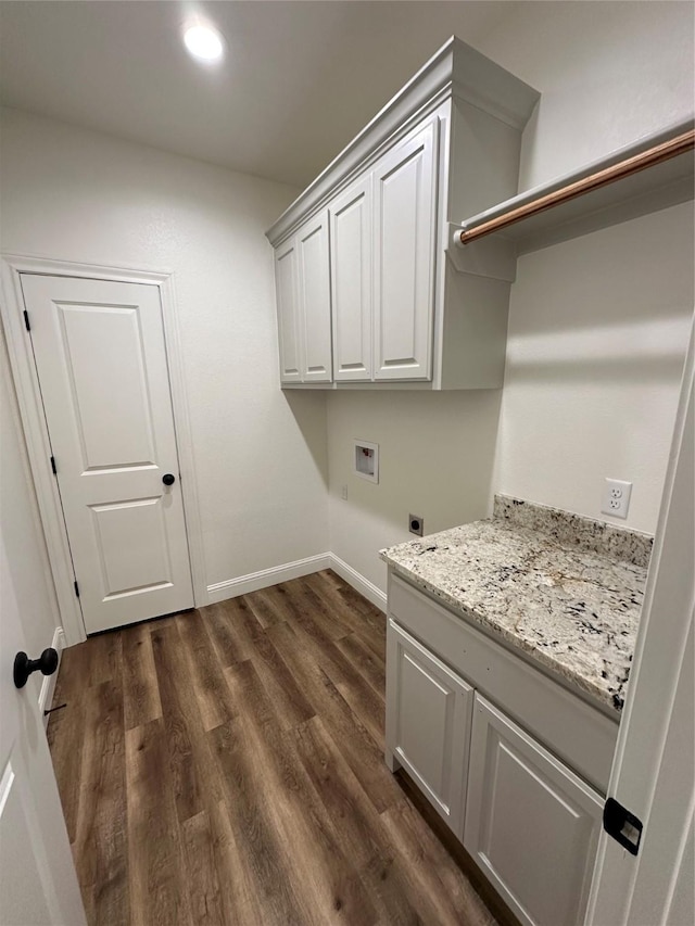 laundry area featuring cabinets, hookup for a washing machine, dark hardwood / wood-style floors, and hookup for an electric dryer