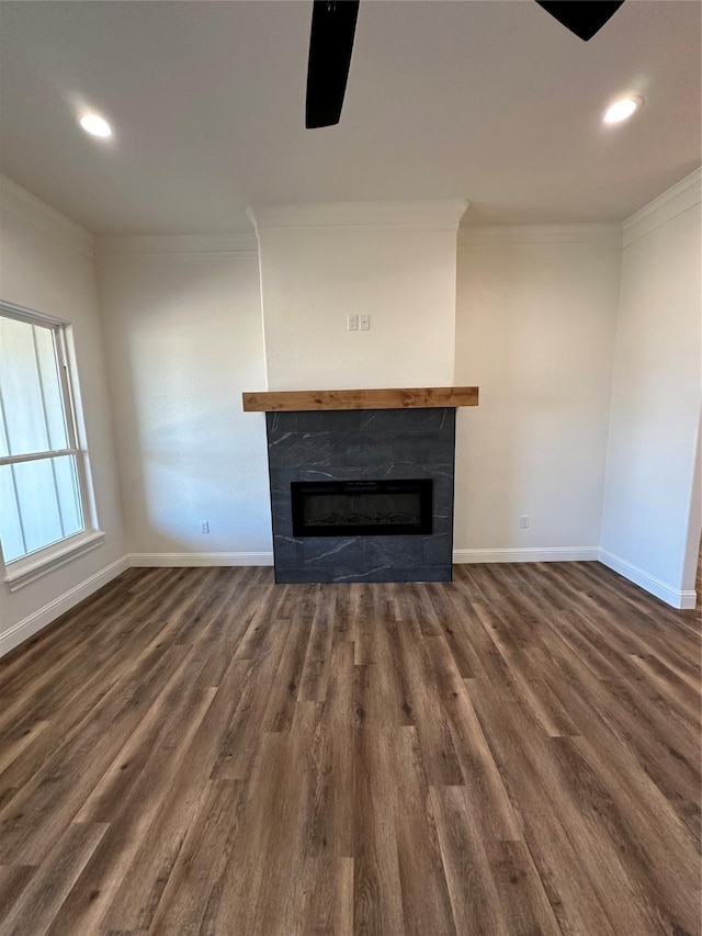 unfurnished living room featuring dark hardwood / wood-style flooring, crown molding, and a tile fireplace