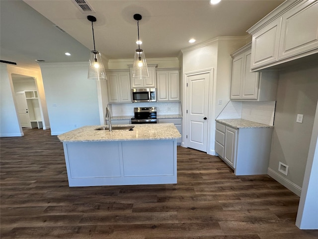 kitchen with tasteful backsplash, sink, stainless steel appliances, dark hardwood / wood-style flooring, and light stone counters